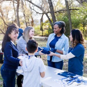 a community event table handing out t-shirts