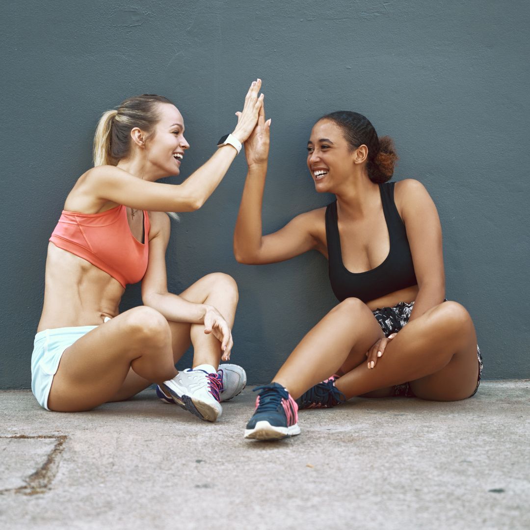 women high fiving after a workout