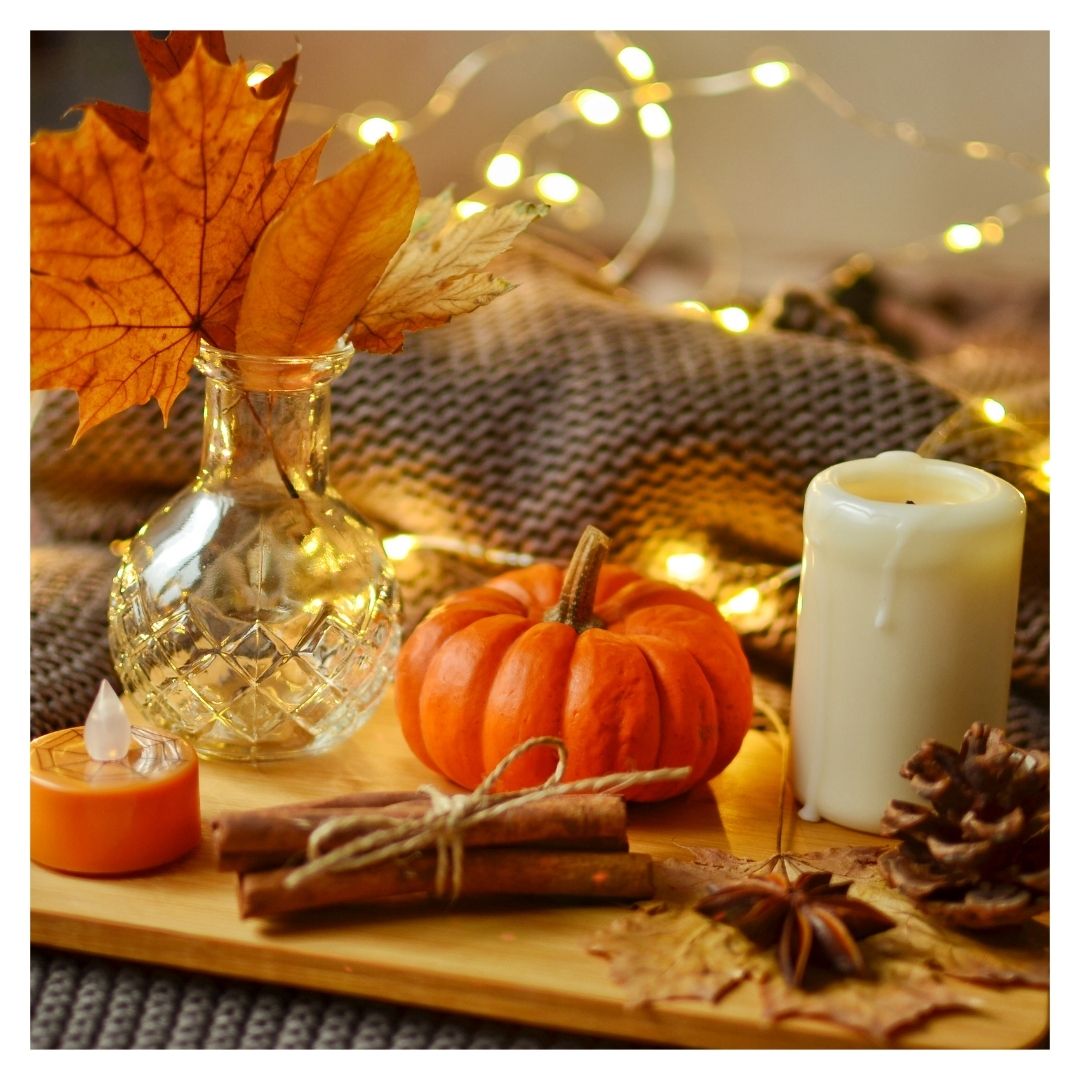 fall arrangement with string lights, cinnamon, and a little pumpkin