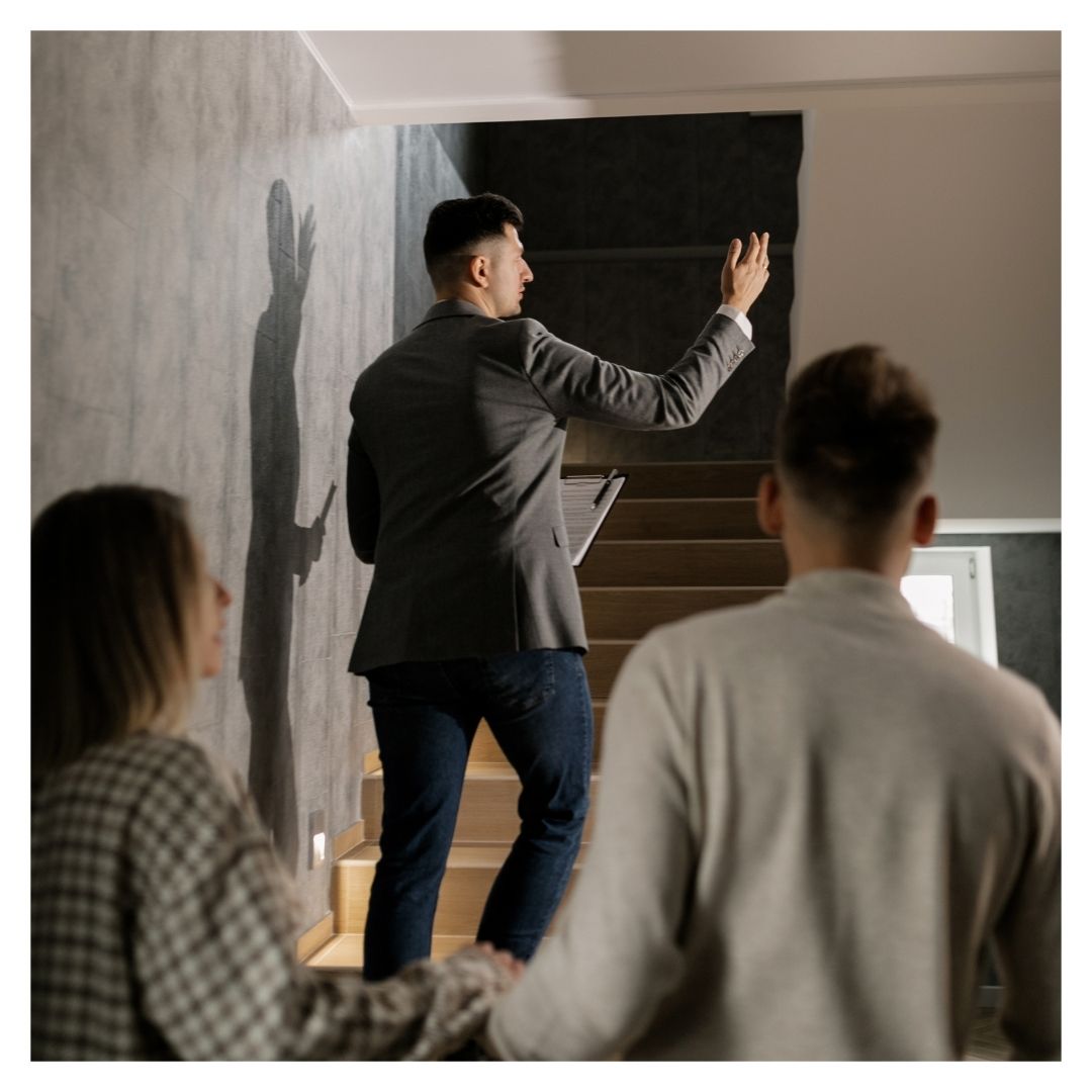 a couple walking through an apartment with a leasing agent